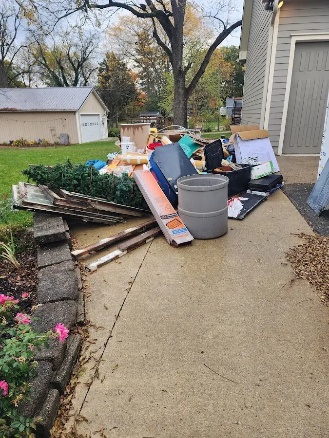 Dumpster being loaded with debris for Commercial Dumpster Rental in Oak Park